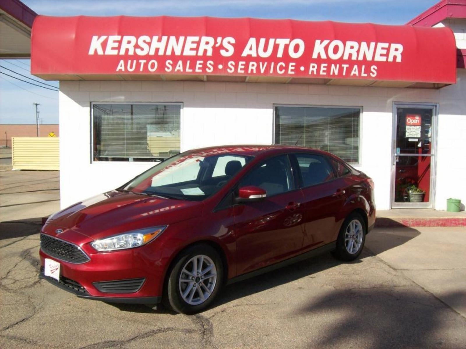 2015 Red /Graphite Grey Ford Focus SE (1FADP3F29FL) with an L4, 2.0L; FFV engine, Automatic transmission, located at 220 West South St., Hastings, NE, 68901, (402) 461-3161, 40.582653, -98.383919 - Great Gas Mileage, Back-up Camera, 25,xxx Miles - Photo #0
