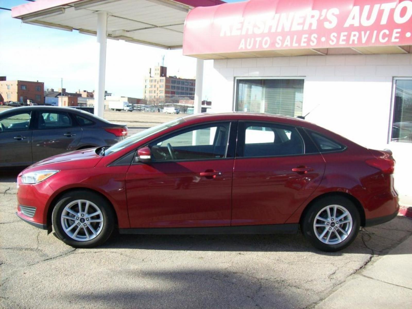 2015 Red /Graphite Grey Ford Focus SE (1FADP3F29FL) with an L4, 2.0L; FFV engine, Automatic transmission, located at 220 West South St., Hastings, NE, 68901, (402) 461-3161, 40.582653, -98.383919 - Great Gas Mileage, Back-up Camera, 25,xxx Miles - Photo #1