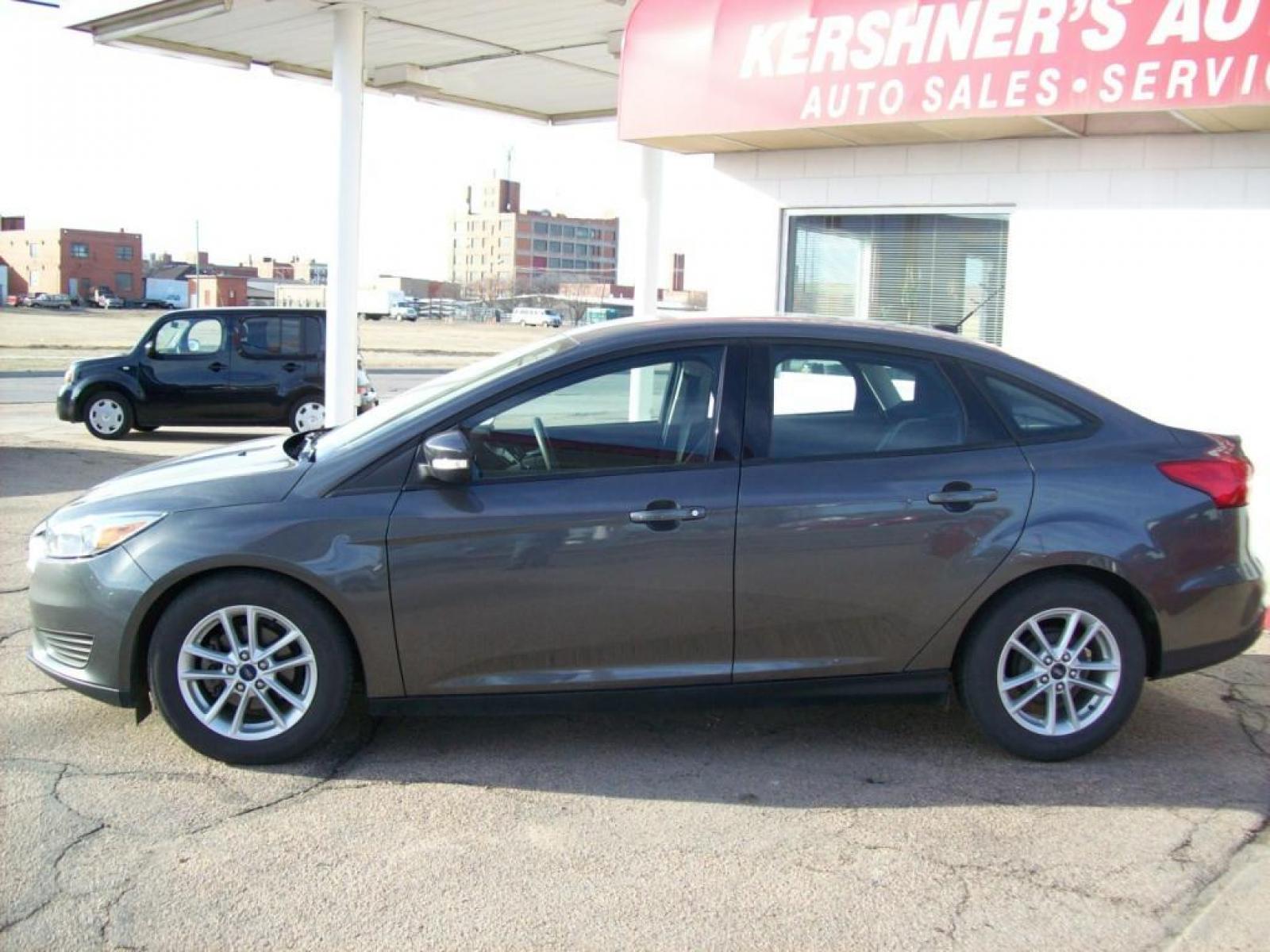 2015 Grey /Graphite Grey Ford Focus SE (1FADP3F21FL) with an L4, 2.0L; FFV engine, Automatic transmission, located at 220 West South St., Hastings, NE, 68901, (402) 461-3161, 40.582653, -98.383919 - Great Gas Mileage, Back-up Camera, 21,xxx Miles - Photo #1